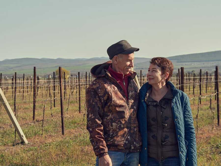 Василий и его жена Любовь позируютна фоне виноградников «Винодельни Марченко»